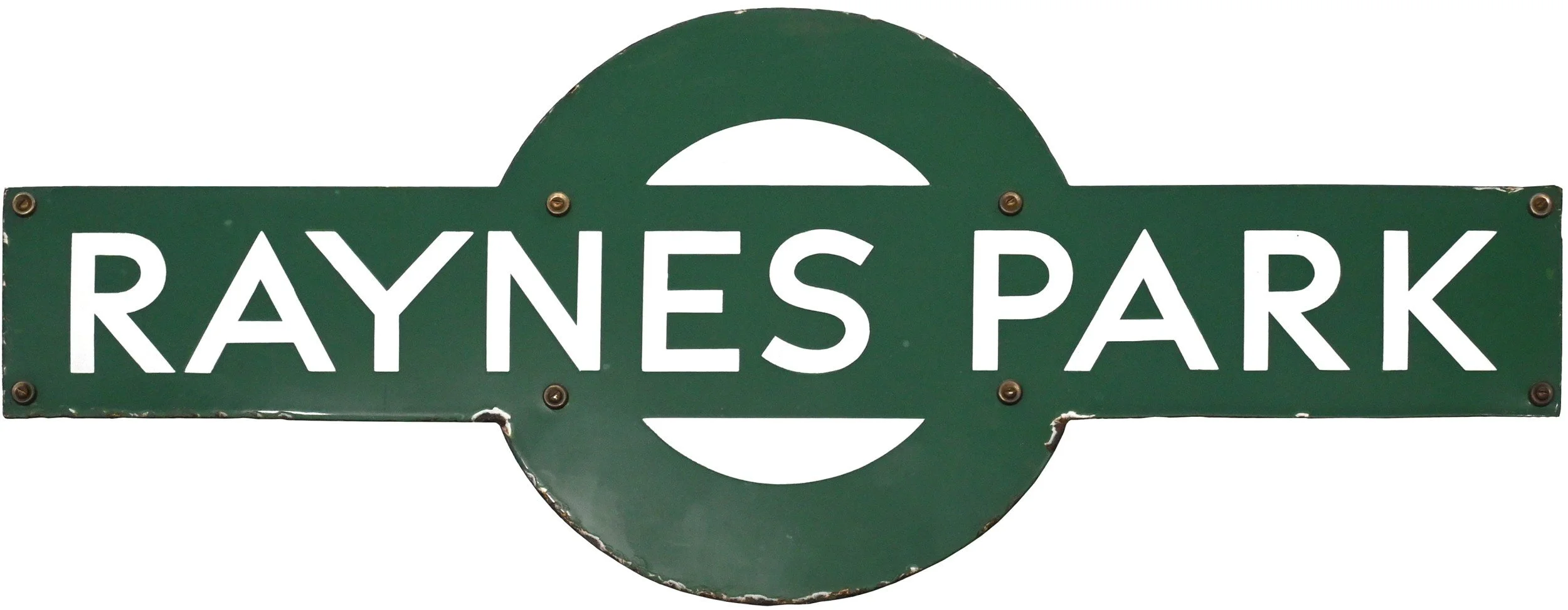 Green railway station Target sign reading 'Raynes Park' with a semi-circular design element at the top center.