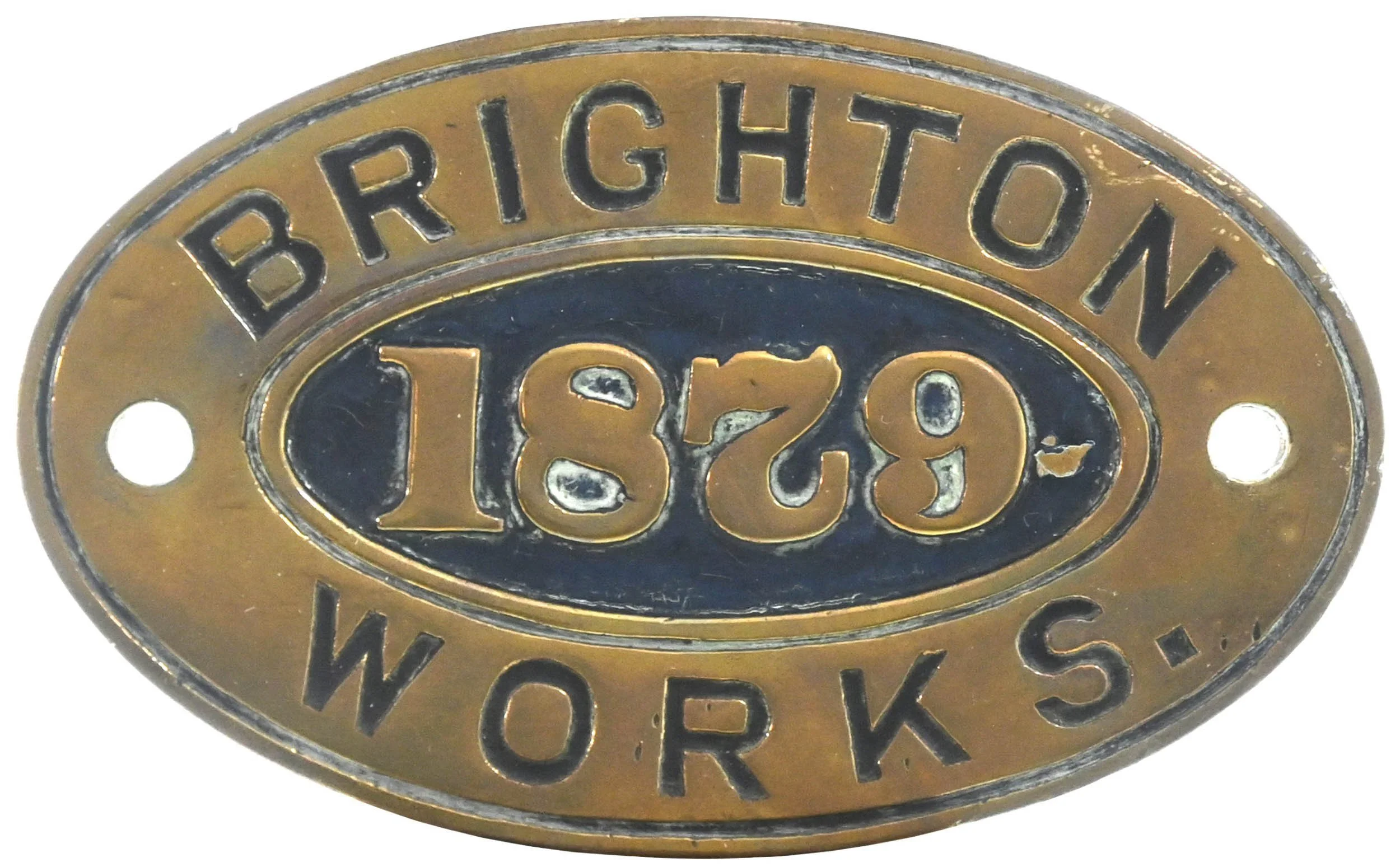Close-up of a brass Brite-Work worksplate with embossed numbers and letters, including '1829' and 'BRIGHTON'.