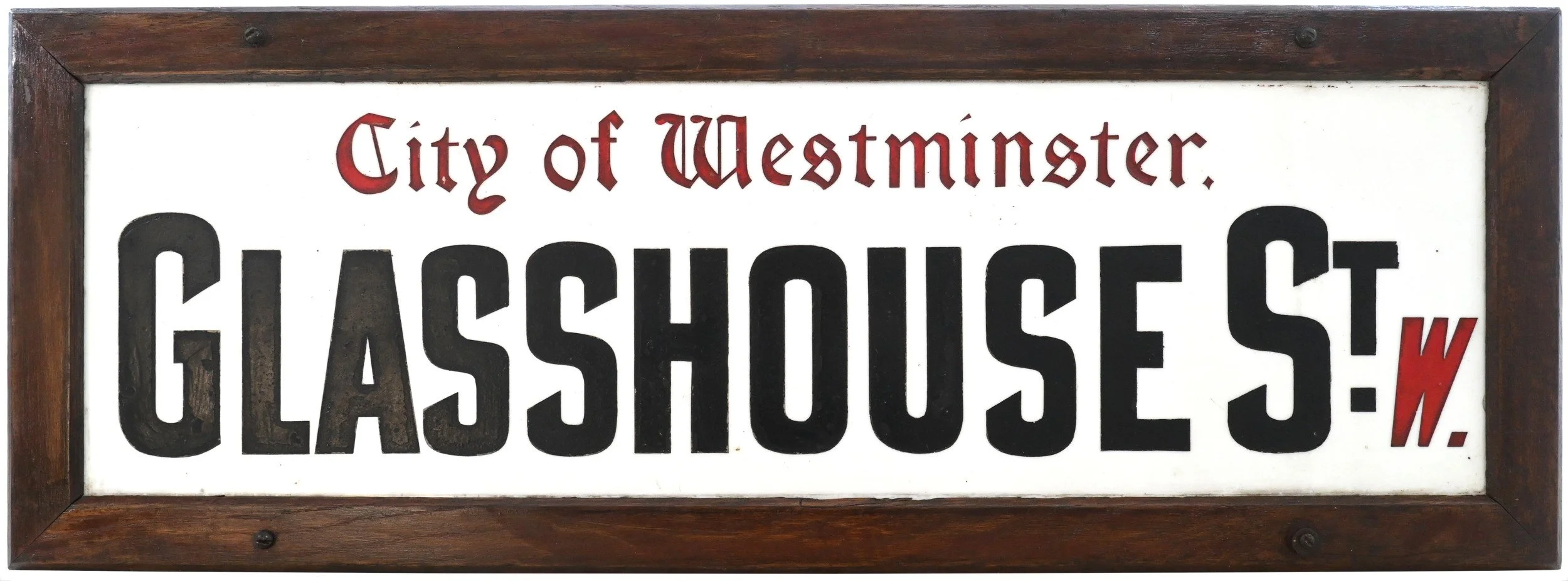 A wooden-framed sign that reads "City of Westminster. Historic House" with the word "HASS HOUSE" in large black letters and a red outline of the letter "W" at the end.