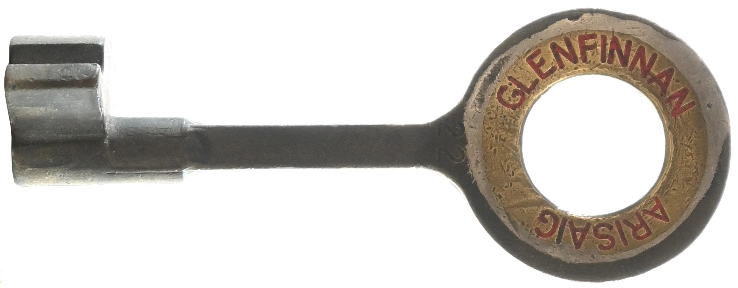A metal key with a ring-shaped end that has a gold-colored circle inside with the red words 'ARISAIEN FINANCIAL' written around it.