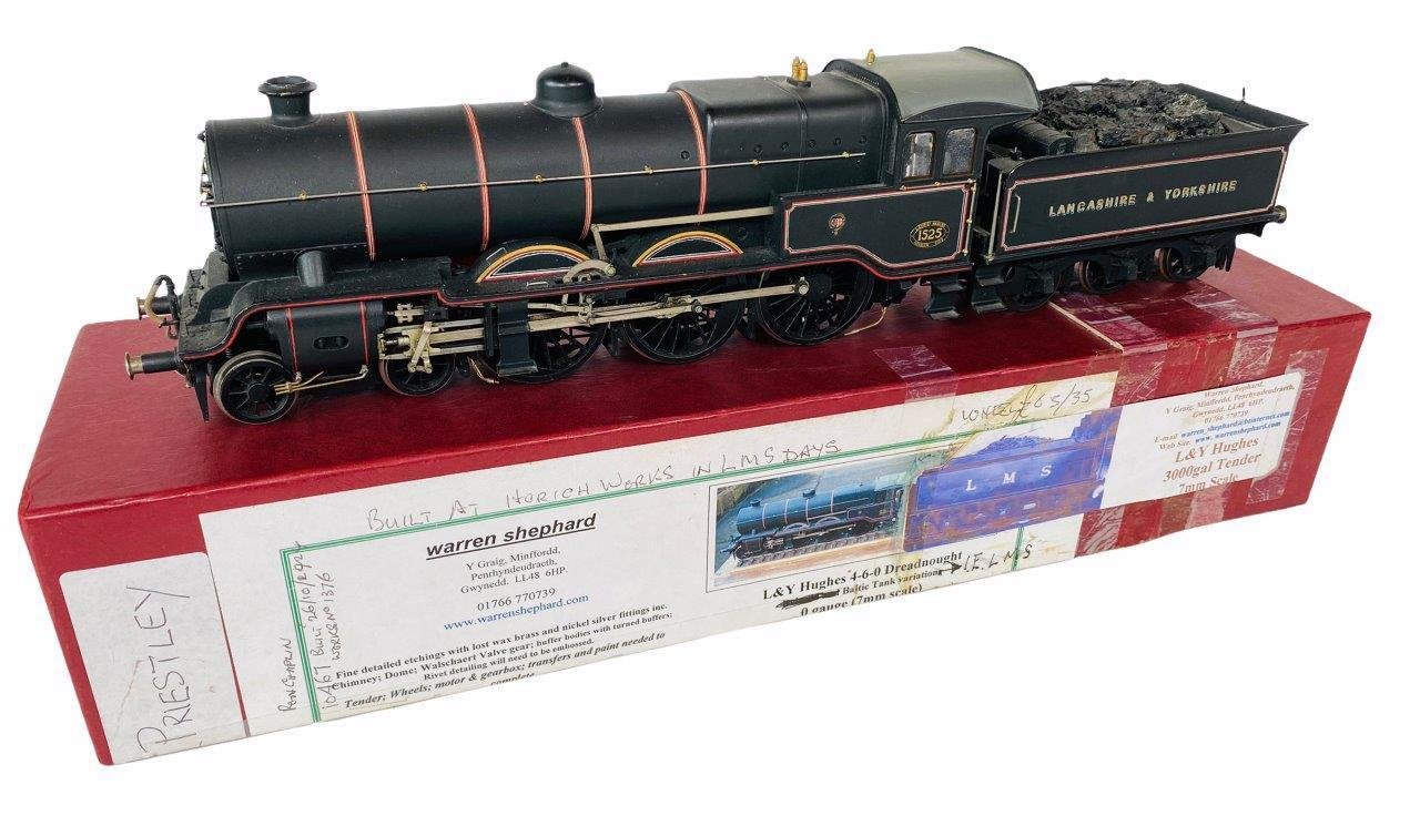 Model black steam locomotive train with red and gold accents on red display box.