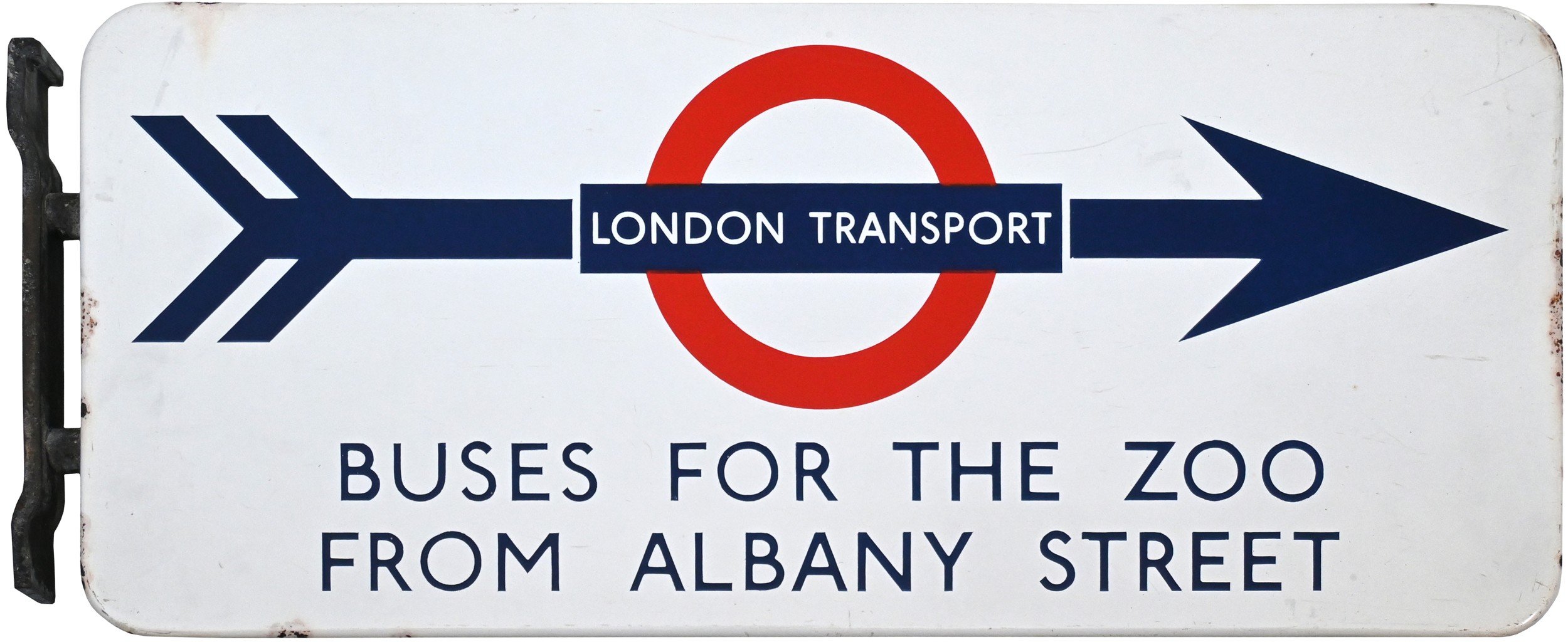 A sign with a directional arrow pointing right. It features the London Underground roundel symbol with a red circle and a blue bar that reads 'LONDON TRANSPORT'. Below the arrow, text indicates 'BUSES FOR THE ZOO FROM ALBANY STREET'.