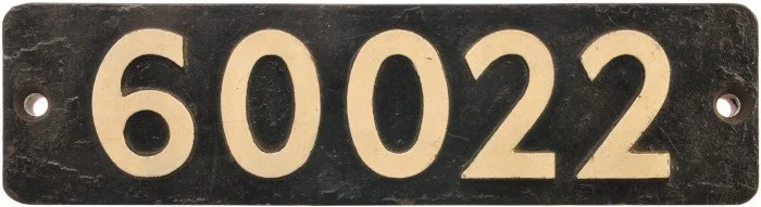 Metal license plate with the number 60022 in large black digits on a white background.