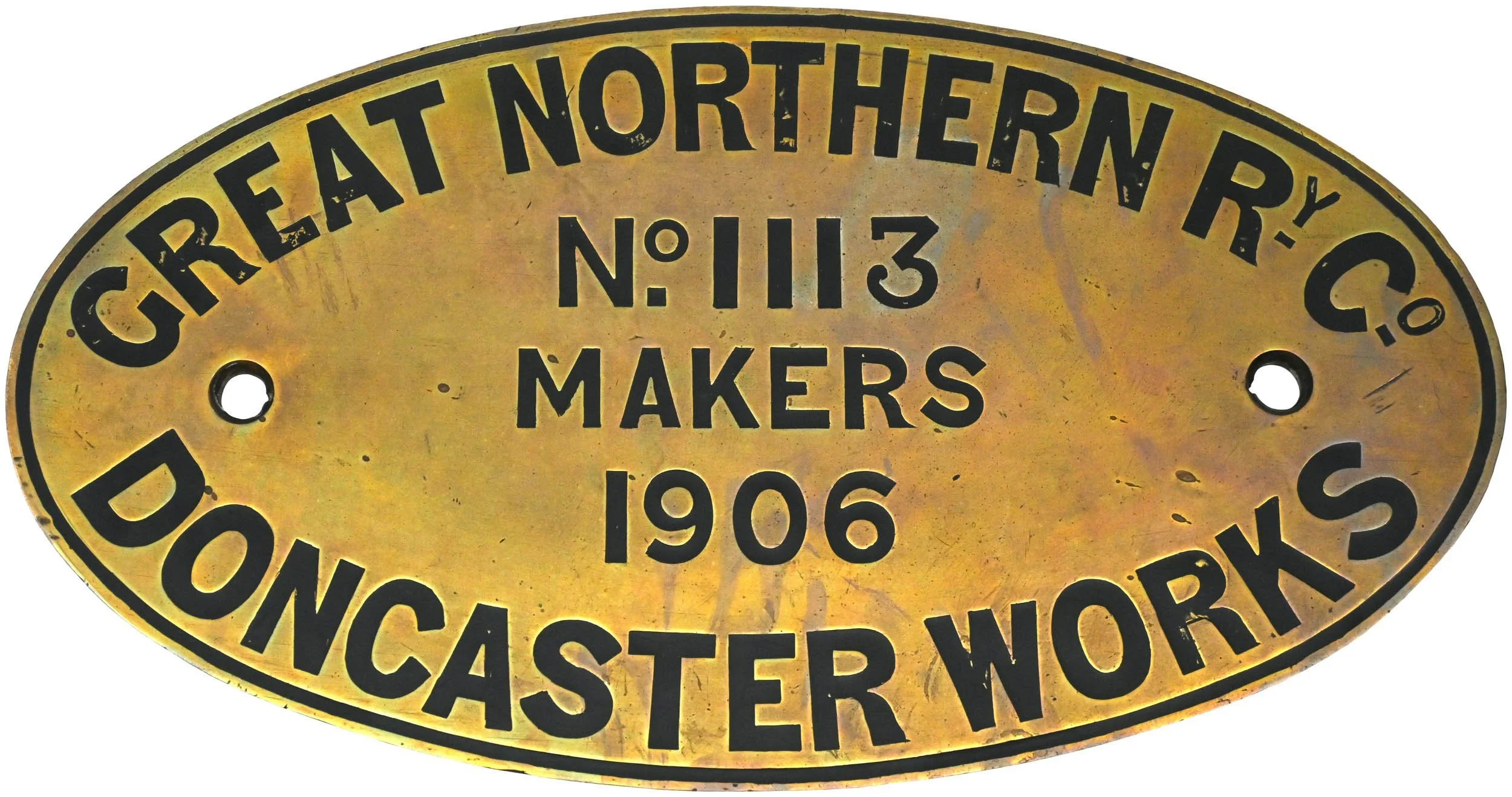 An oval brass plate with black text reading 'Great Northern Railway Co., No. 113, Makers, 1906, Boston, W. No, Caste, Wors'.