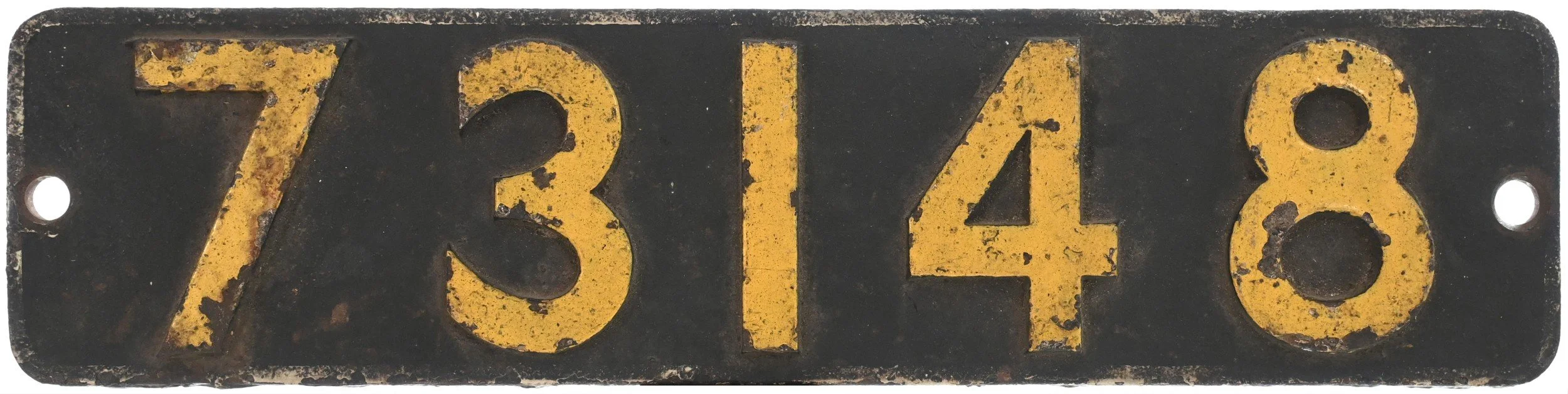 Locomotive Smokebox Numberplate 73148 painted on a black background, showing signs of rust and wear.