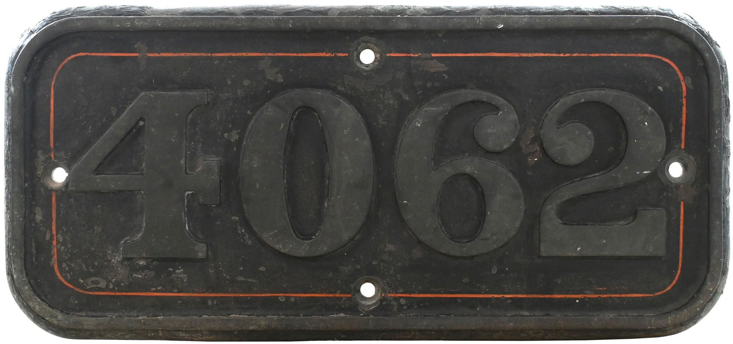 A black plastic license plate with embossed numbers "2062" and a red border, showing signs of wear and dirt.