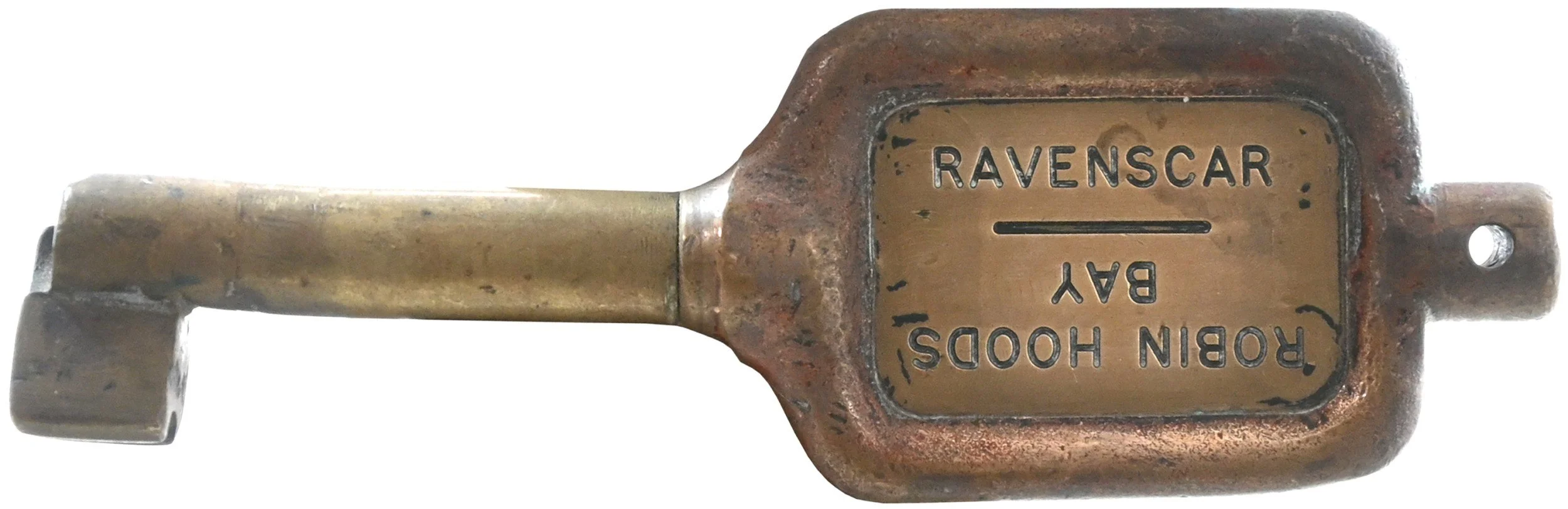 Vintage brass key token with engraved plate reading 'RAVENSCR BAR' and 'BAR' repeated.