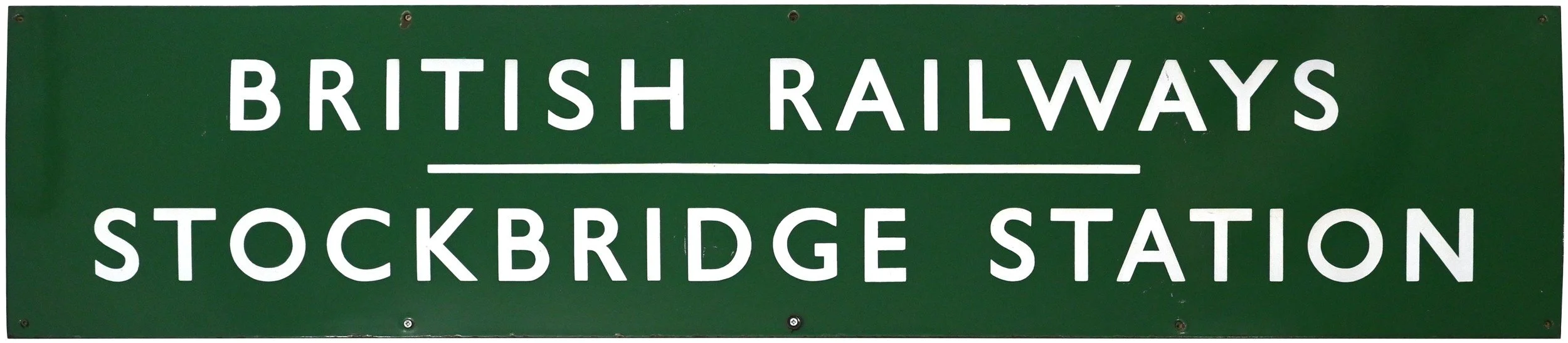 Green railway sign with white text that reads "British Railways" at the top, with "Stockbridge Station" underneath.