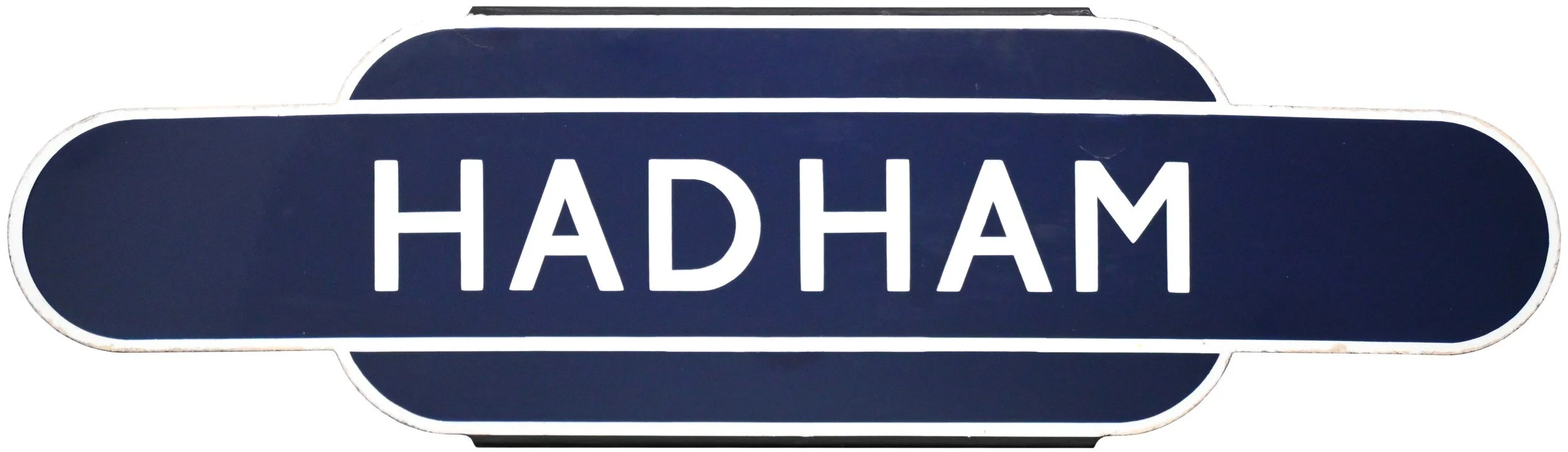 A railway station Totem sign with the name 'HADHAM', written in white capital letters on a dark blue background, with a rounded rectangular shape and white border.
