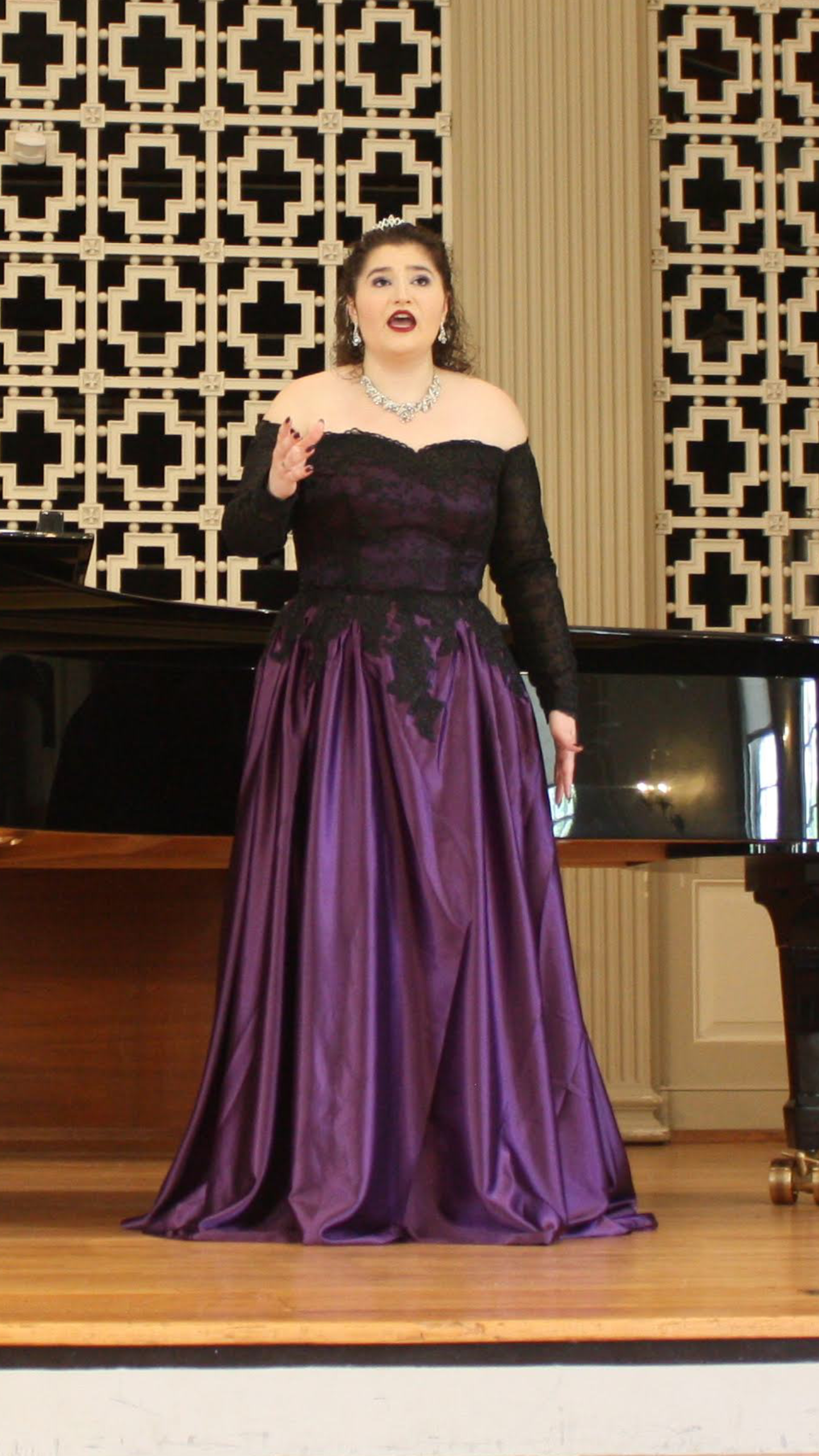 Amy Brandt performing and acting while singing in a recital. Brandt Voice Studio founder and singing teacher
