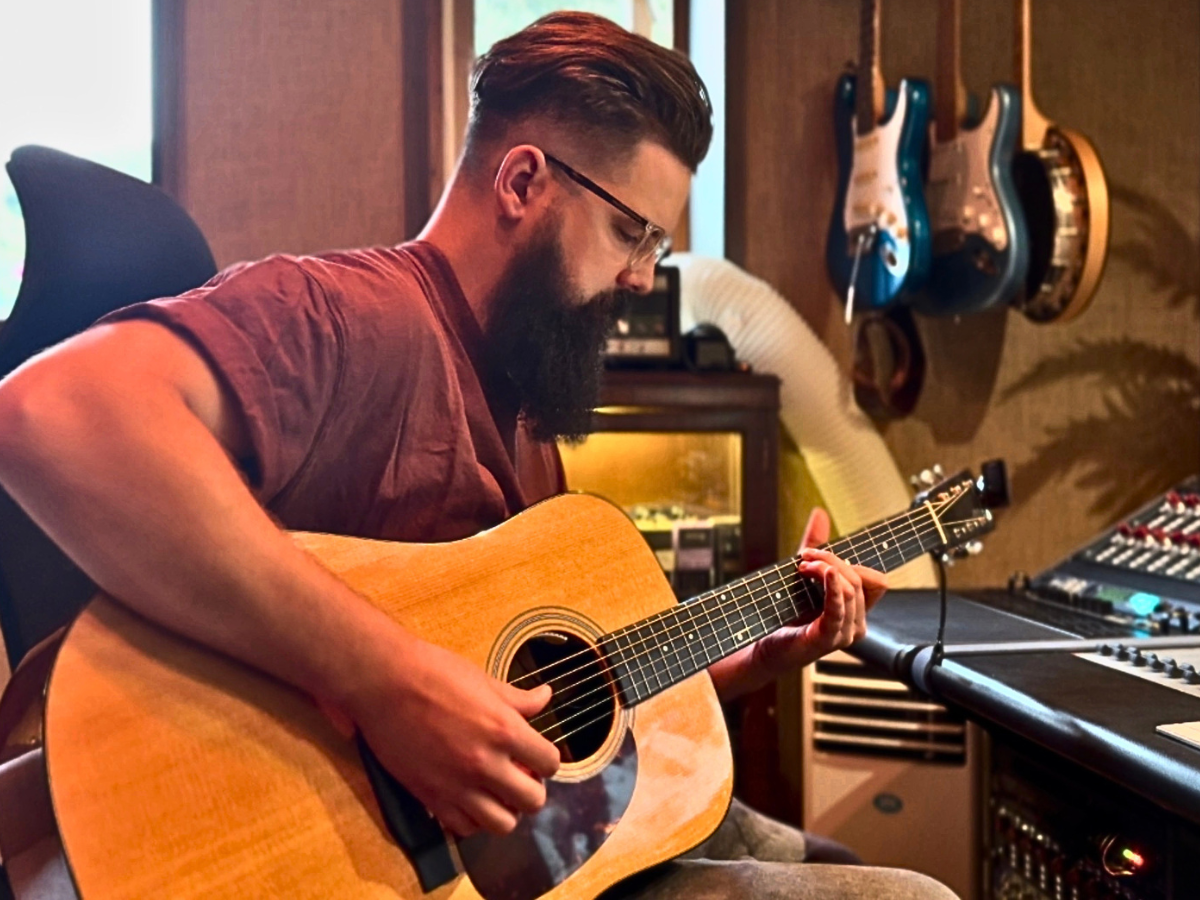 Josiah playing acoustic guitar