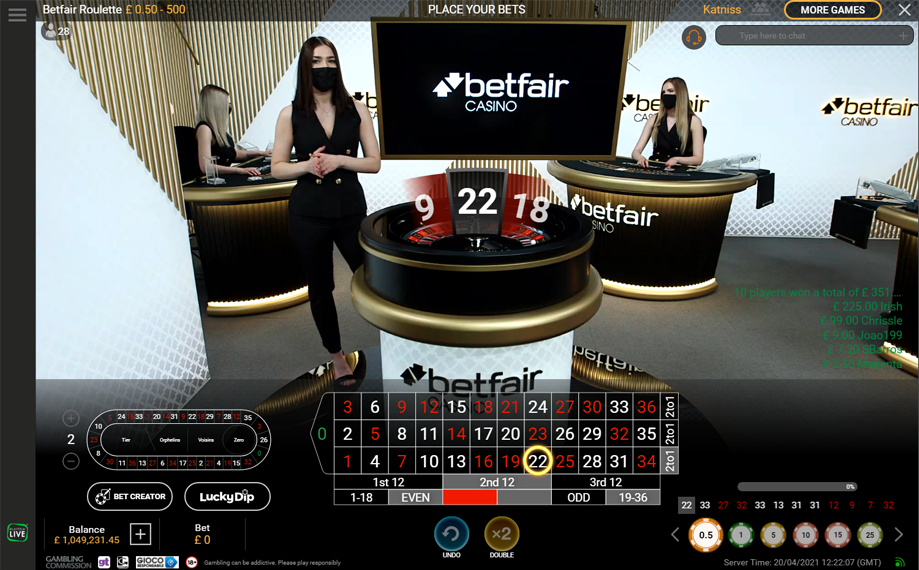 Screenshot of an online roulette game at Betfair Casino with dealers, a roulette wheel showing the number 22, and various betting options and statistics.