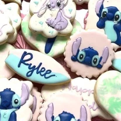 Sugar cookies decorated with ice cream, Digimon character, and the name 'Rylee' in blue icing.