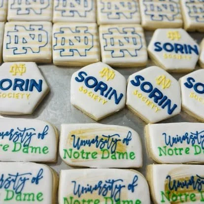 Sugar cookies decorated with Notre Dame logos and the word "SORIN" in blue and yellow icing.