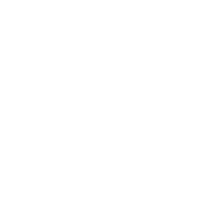 Two people sitting at a table with a clock on the wall behind them.