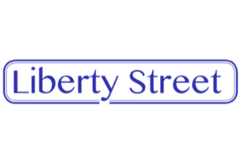 Sign that reads 'Liberty Street' in blue neon lights.