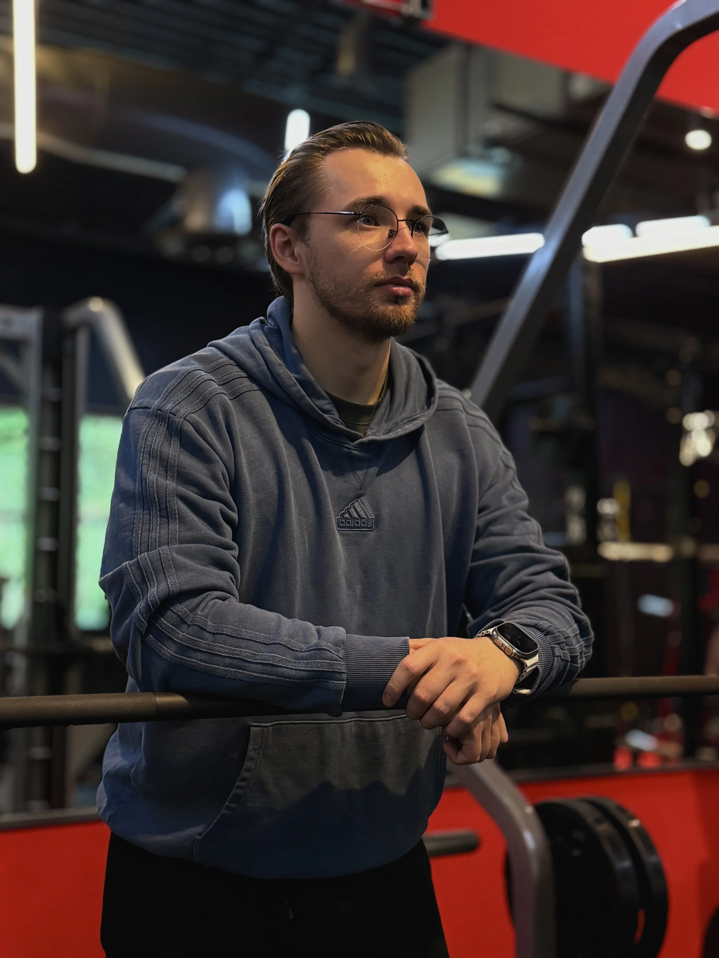 Bohdan Melnyk, a personal trainer in Redmond, WA, standing near gym equipment.