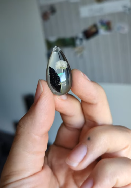 made for a bride with a piece of her fathers shirt, a real opal and a small white flower