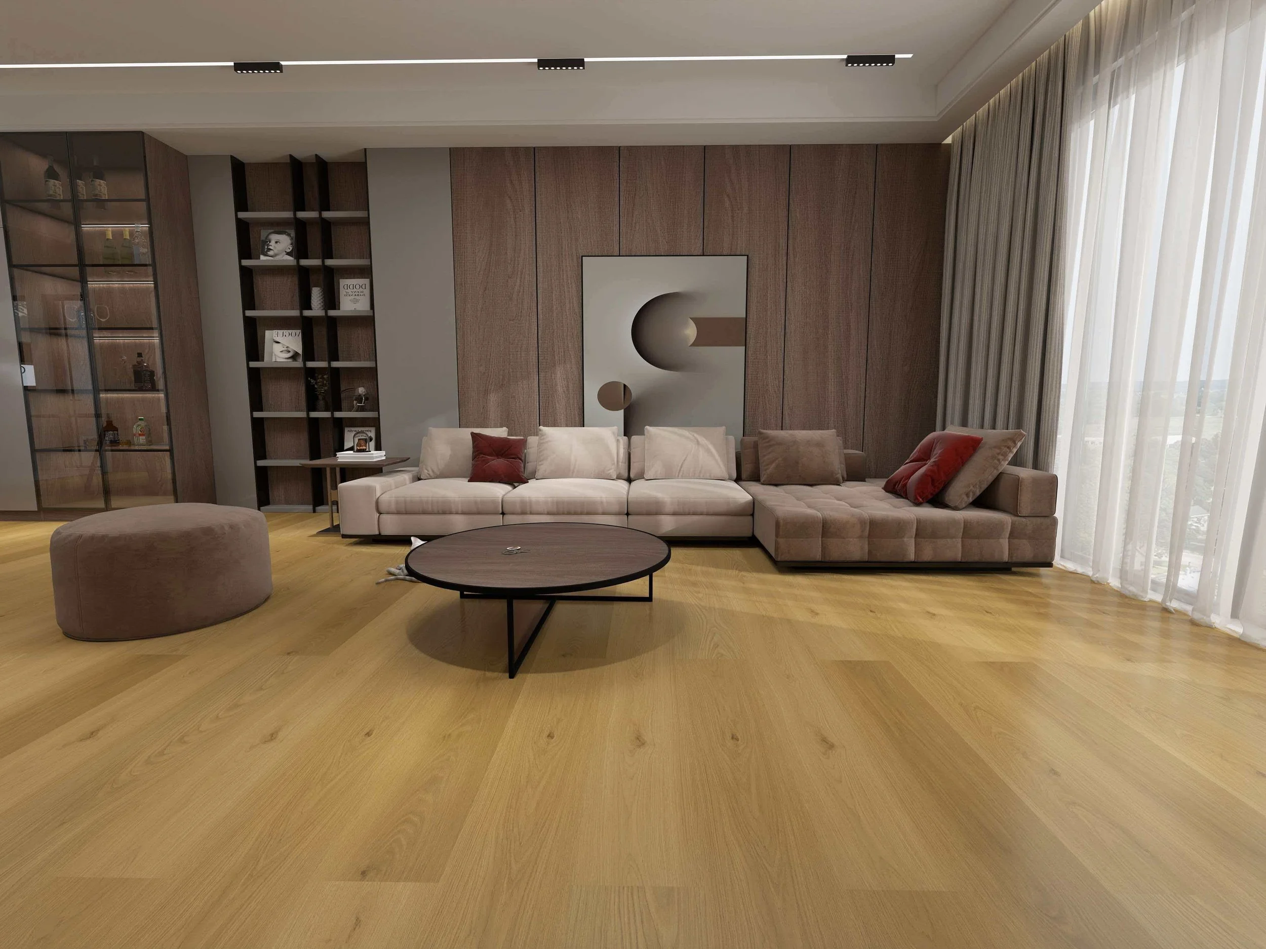 Modern living room with beige sectional sofa, round black coffee table, soft pillows, wood-paneled wall, abstract art, bookshelf, and large window with sheer curtains.
