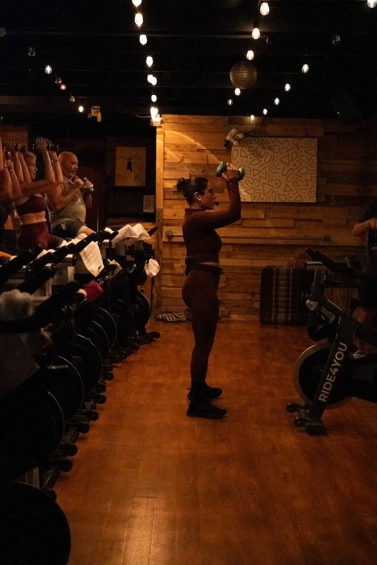 instructor leading an indoor cycling class