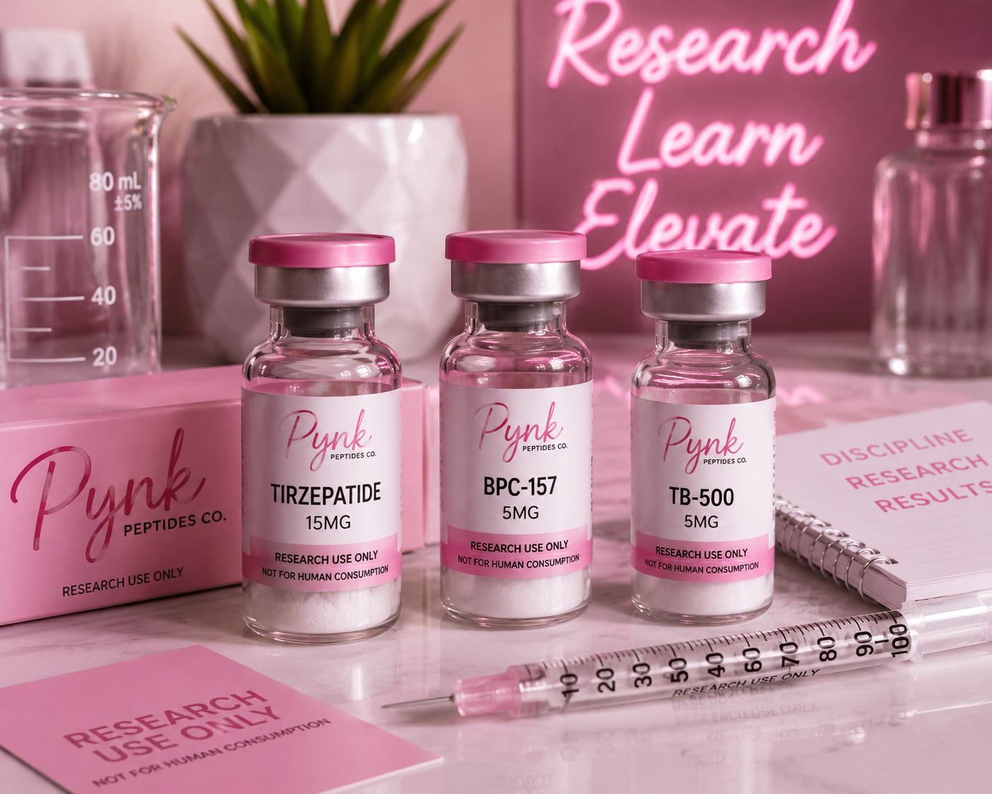 Three small glass vials labeled with pink and white labels, containing research chemicals named Tirzepatide, BPC-157, and TB-500, placed on a pink counter with research notes, a syringe, and laboratory glassware around them. A pink neon sign in the background reads 'Research Learn Elevate'.