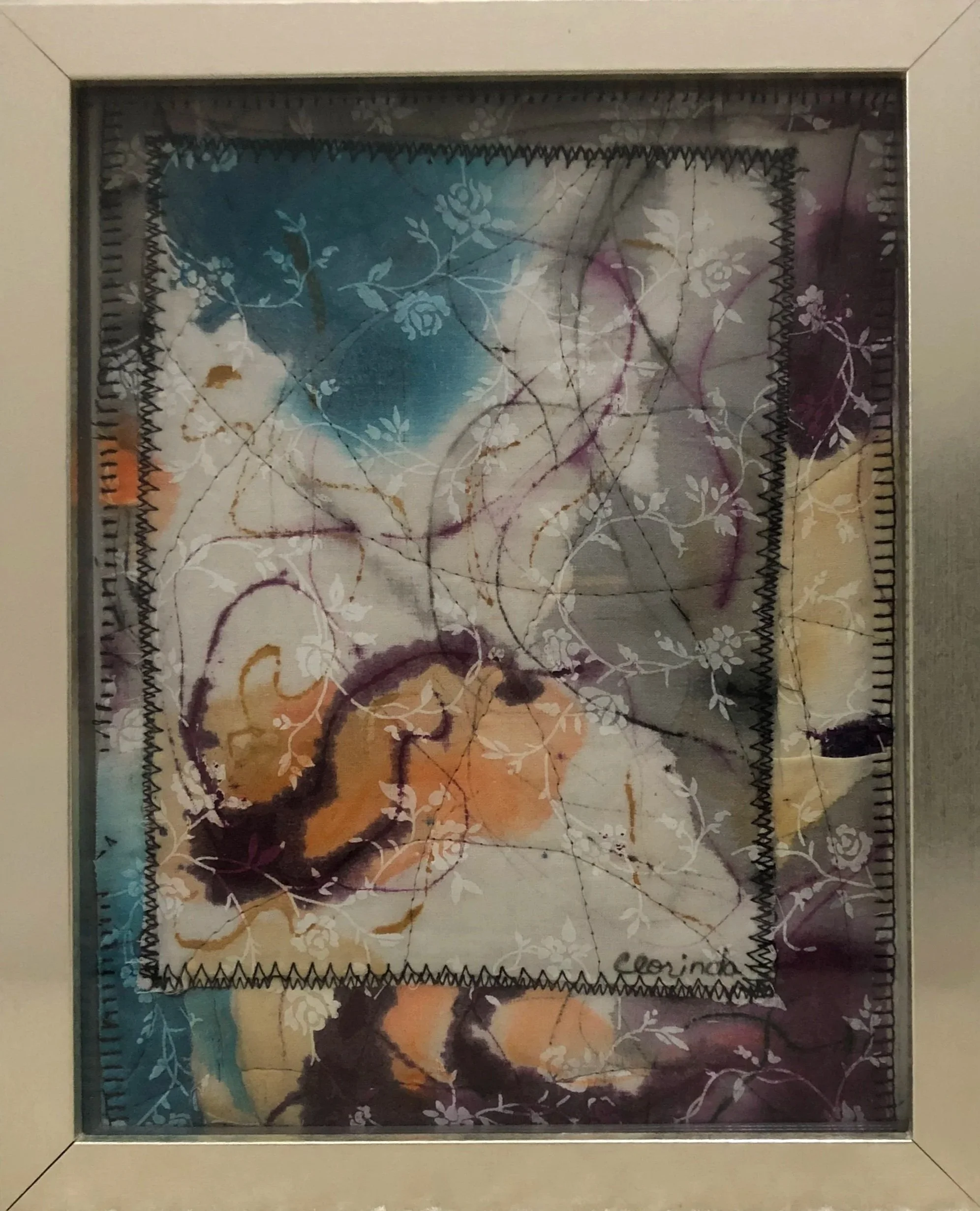 A framed piece of artwork with abstract design, featuring swirling lines, floral patterns, and a mix of dark and light colors including shades of purple, yellow, and blue. The artwork is signed with the name 'Clorinda' at the bottom right.