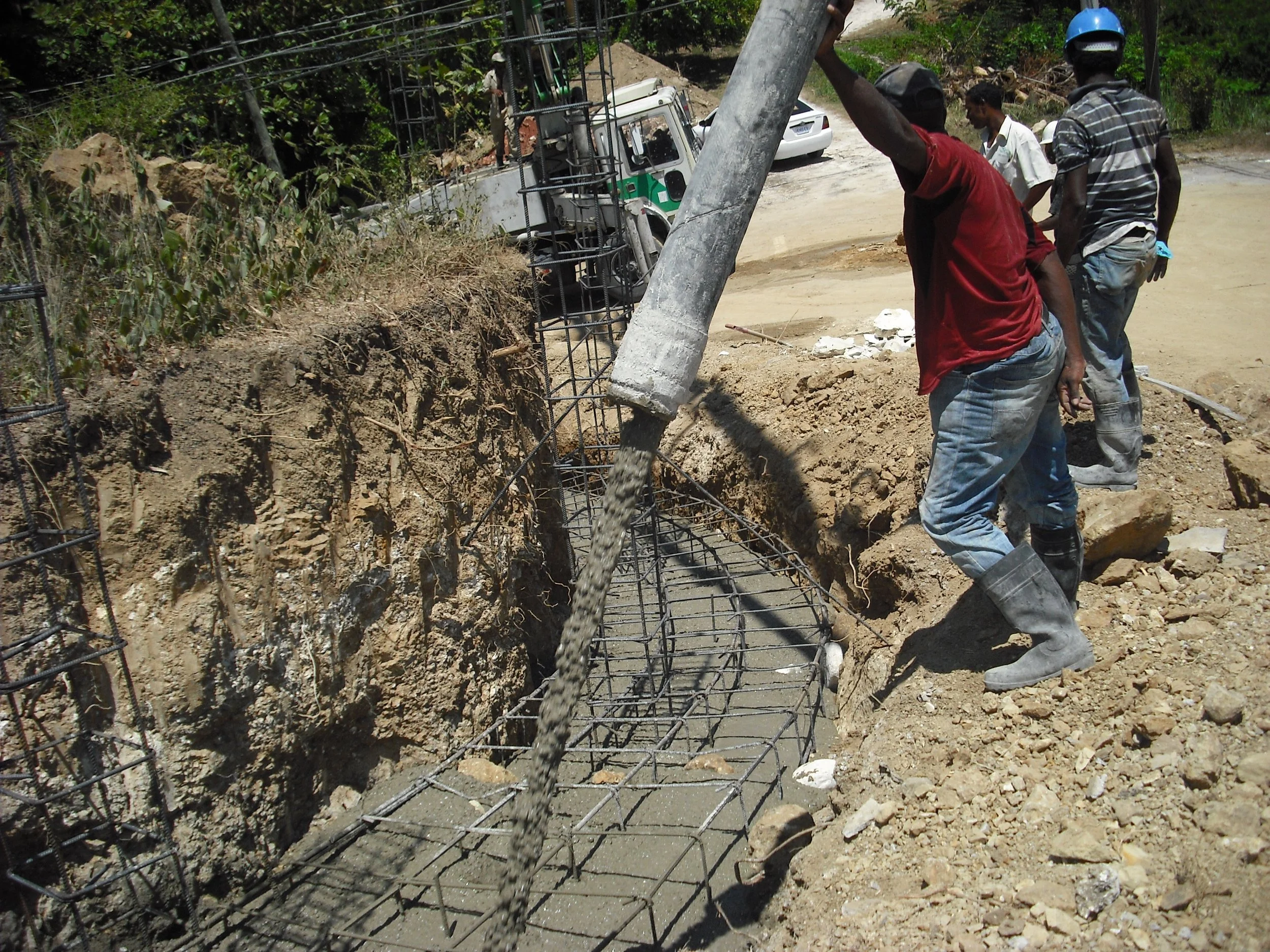 Workers pouring concrete into a foundation 