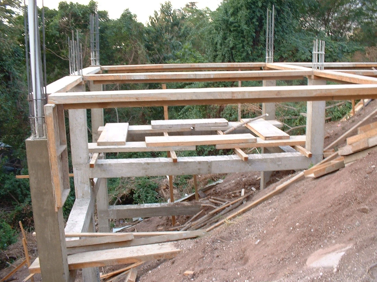 Wooden framework for a building under construction, with trees in the background.