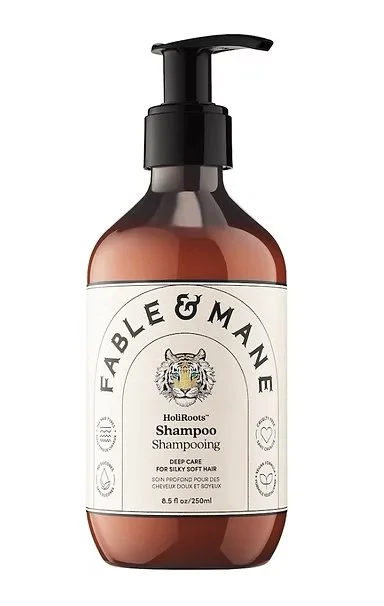 A bottle of Fable & Mane Hour Roots Shampoo for silky soft hair with a pump dispenser.