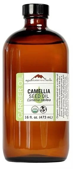 Amber bottle of Mountain Rose Herbs camellia seed oil with green and white label.