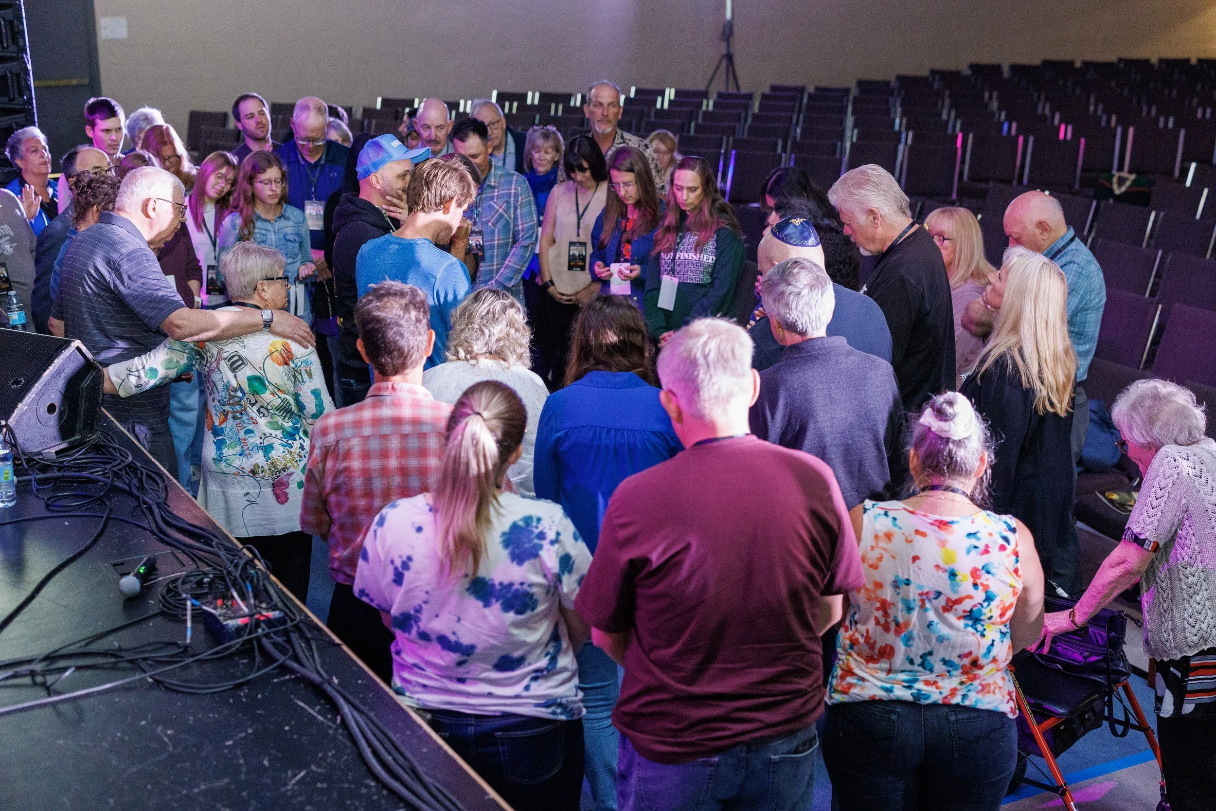 Community members gathered in prayer at an Impact 16:15 event.
