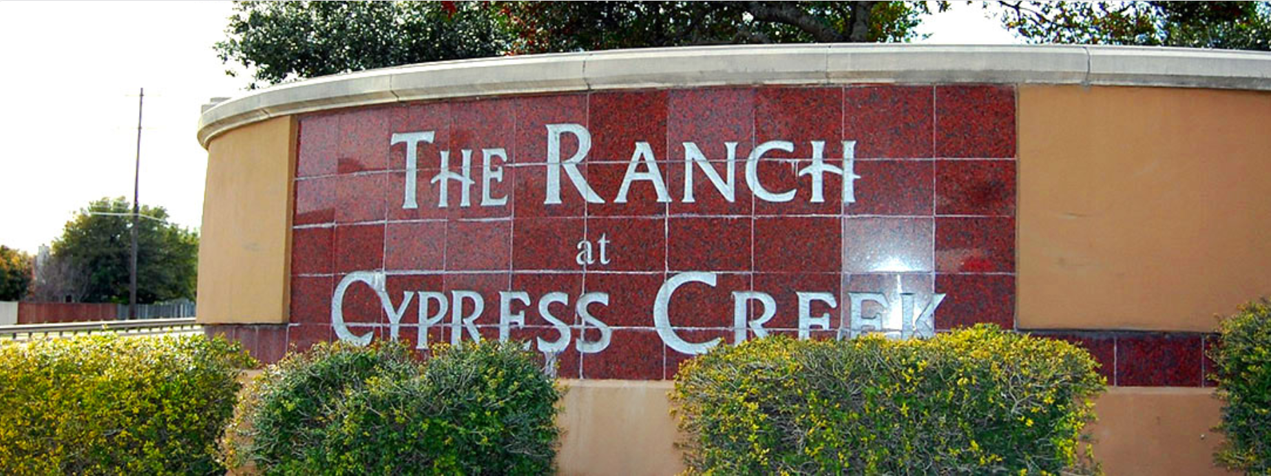 Sign for The Ranch at Cypress Creek, with landscaping in front.