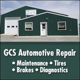 Green automotive repair shop with signage listing maintenance, tires, brakes, diagnostics
