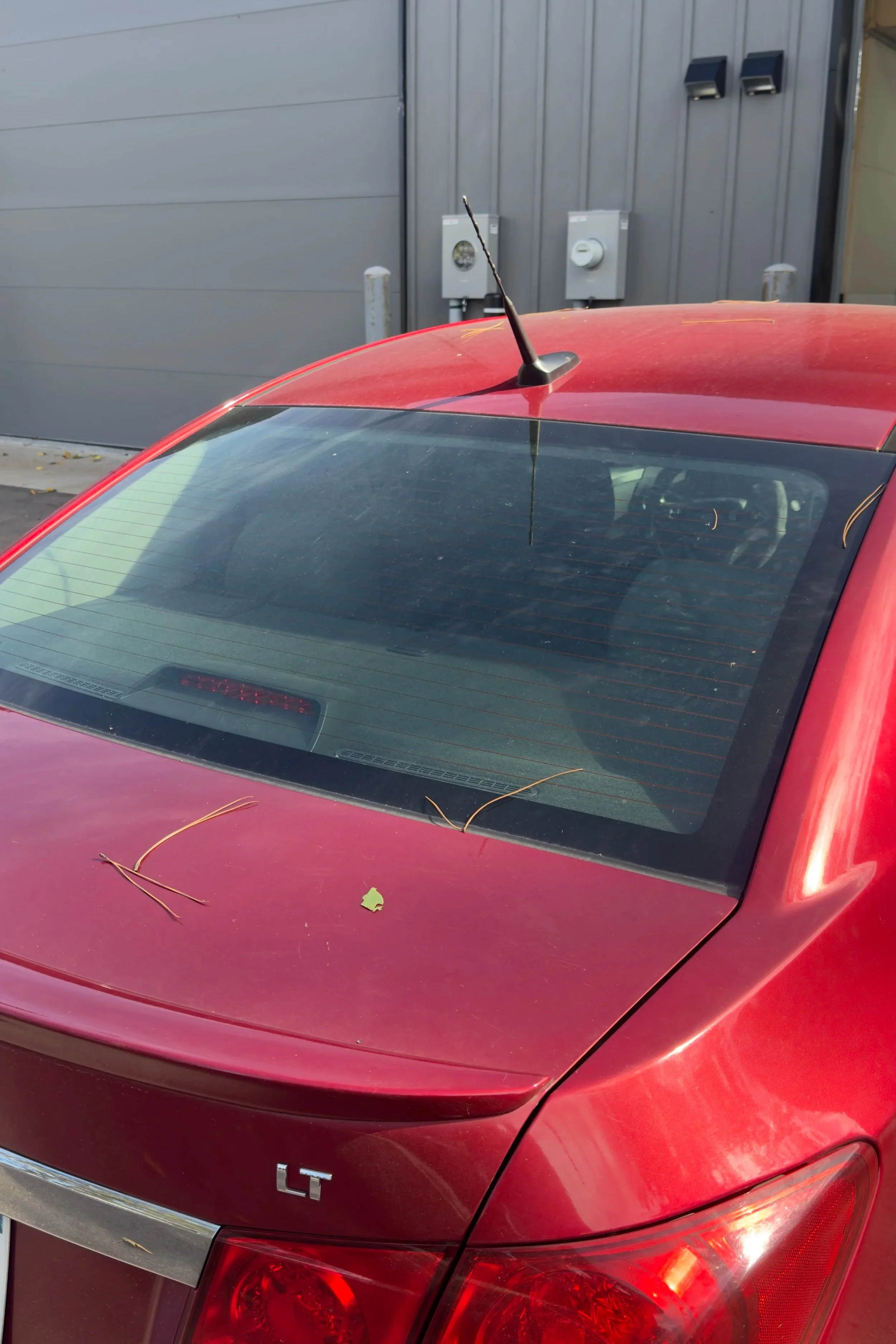 Red Chevrolet Cruze rear windshield before tint installation