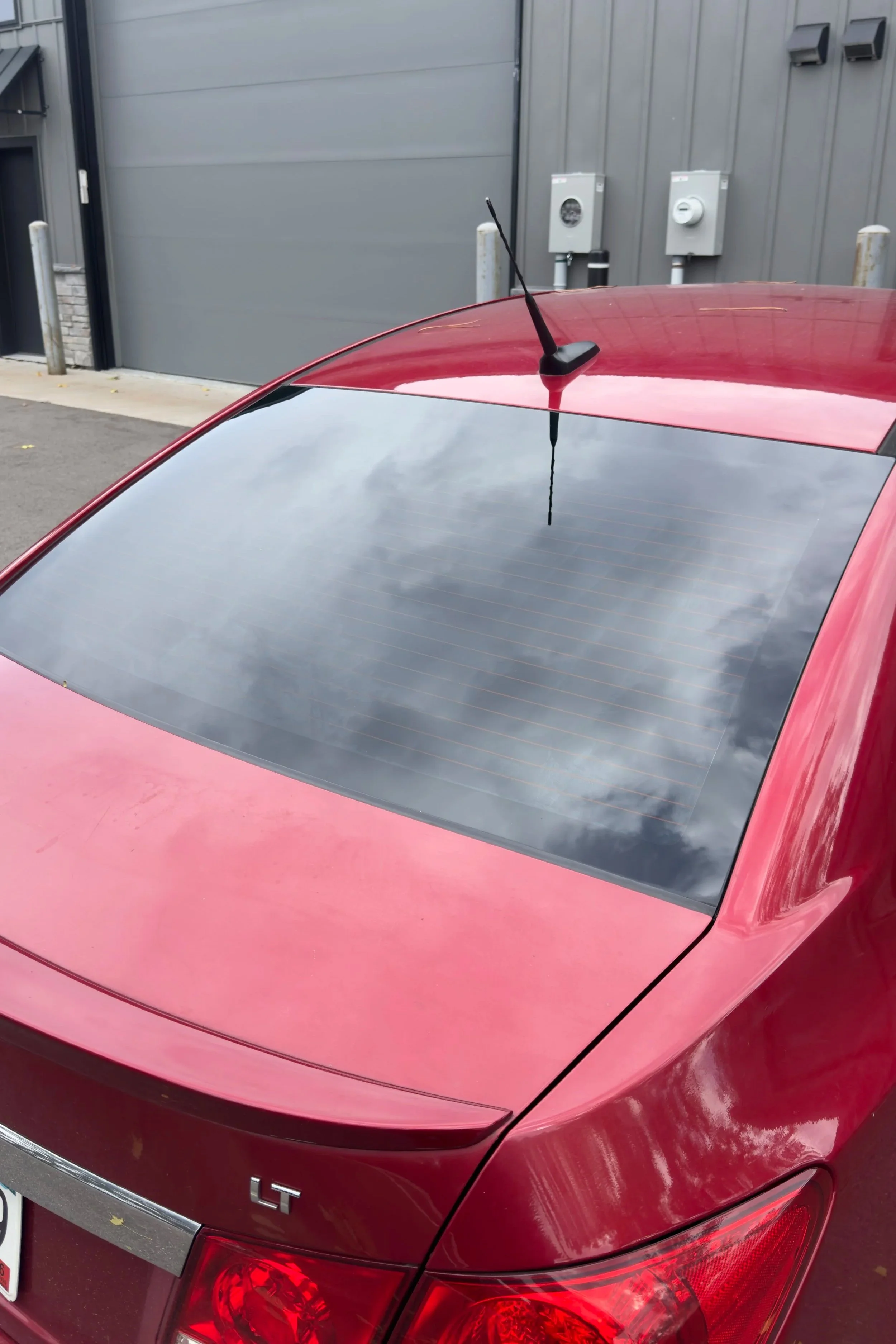 Red Chevrolet Cruze rear windshield after 20% ceramic tint