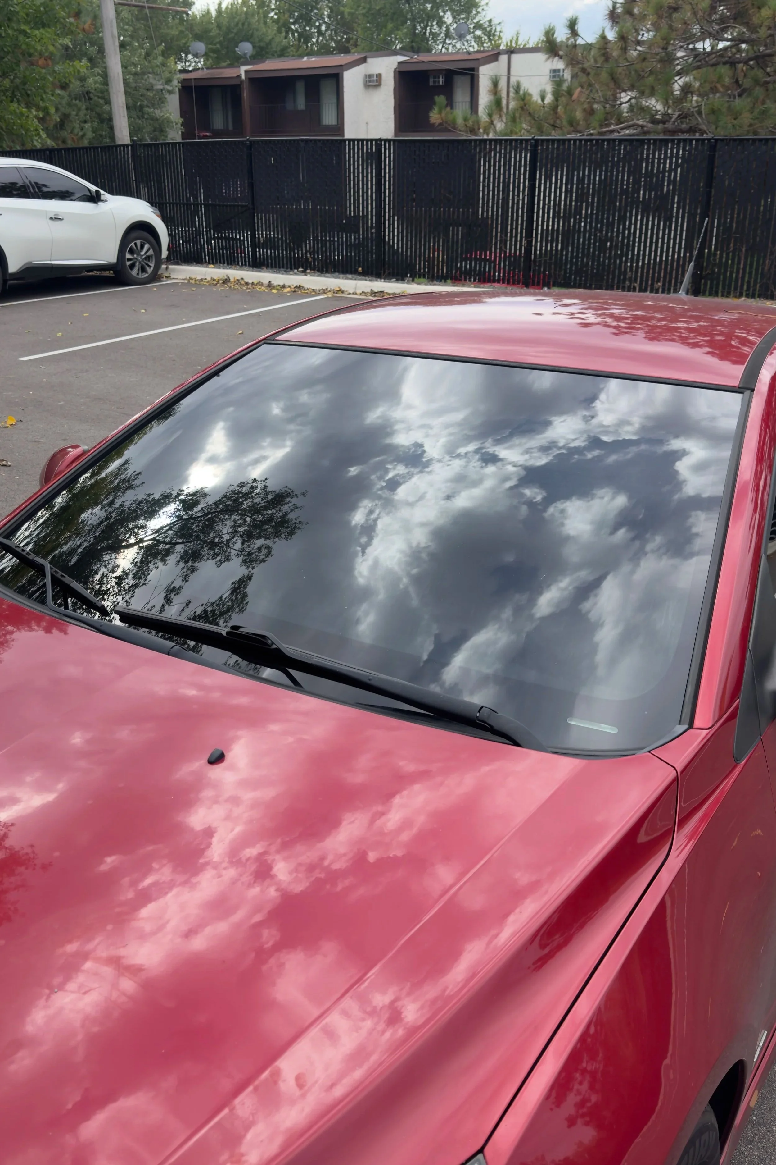 Red Chevrolet Cruze front windshield after 20% ceramic tint