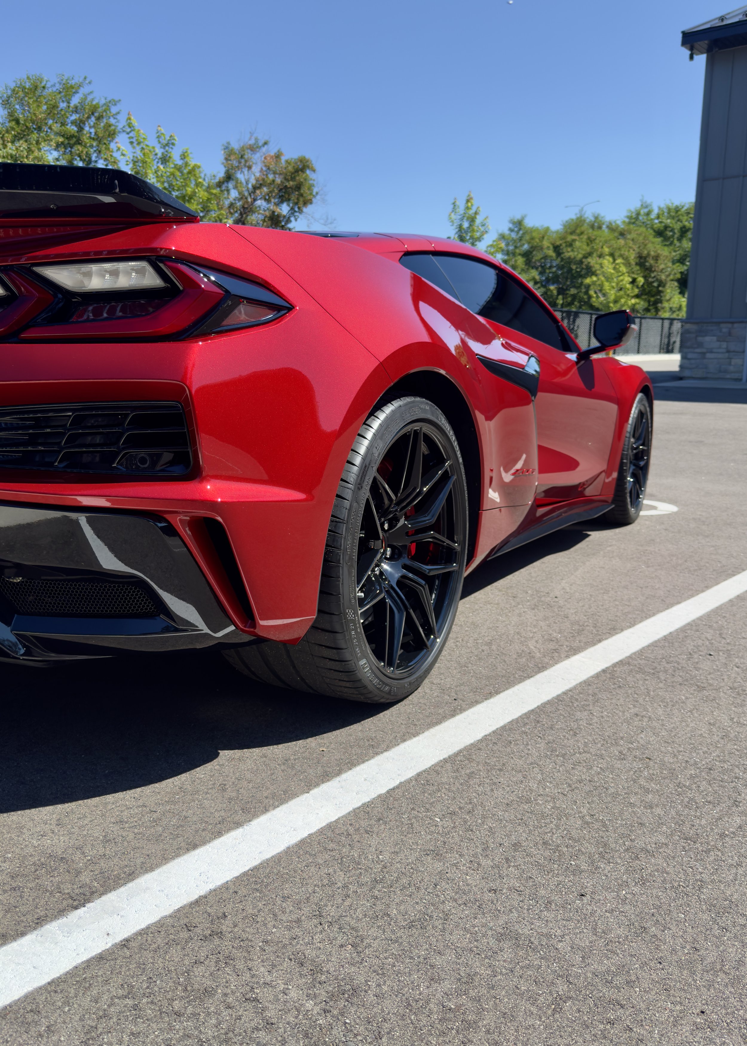 Rear three-quarter view of a red sports car with dark tinted windows.