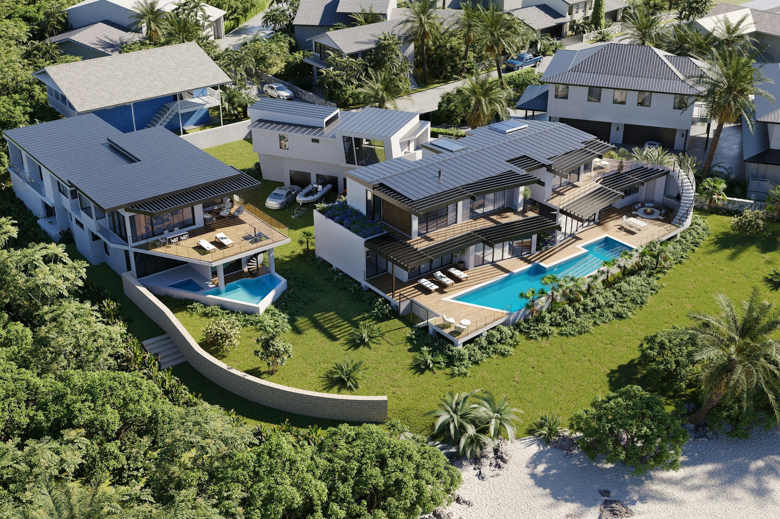 Aerial view of modern beach houses with outdoor pools, surrounded by lush tropical greenery and palm trees, near sandy shoreline.