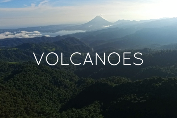 Landscape of green mountains with a distant volcano, the word 'VOLCANOES' overlaid.