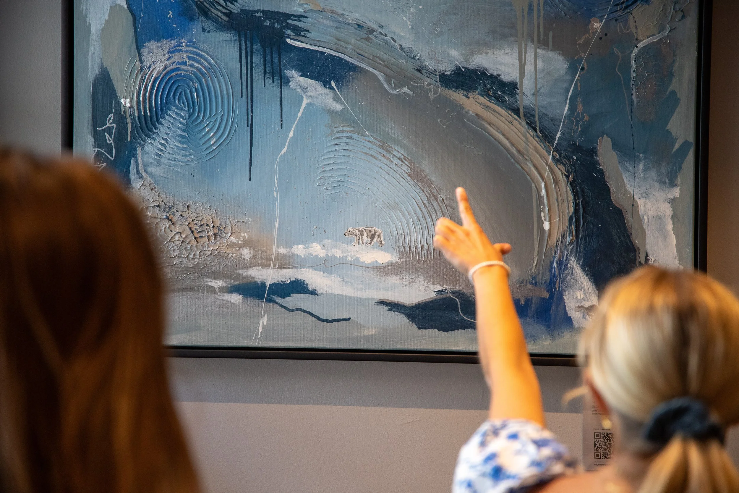 Children observing an abstract painting with swirling blue, gray, and white patterns, featuring a carved fingerprint pattern and a small bear shape at the bottom.