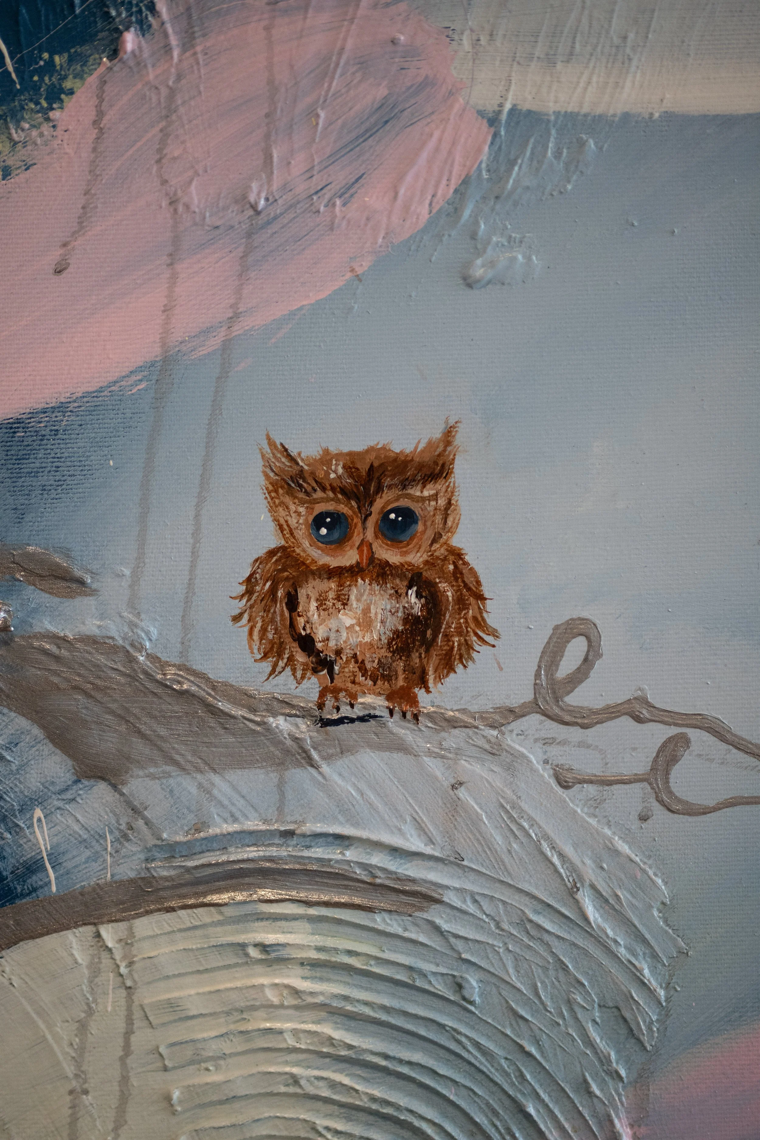 A painting of a cute brown owl with big blue eyes, sitting on a branch against a light blue and grey background with swirling patterns.