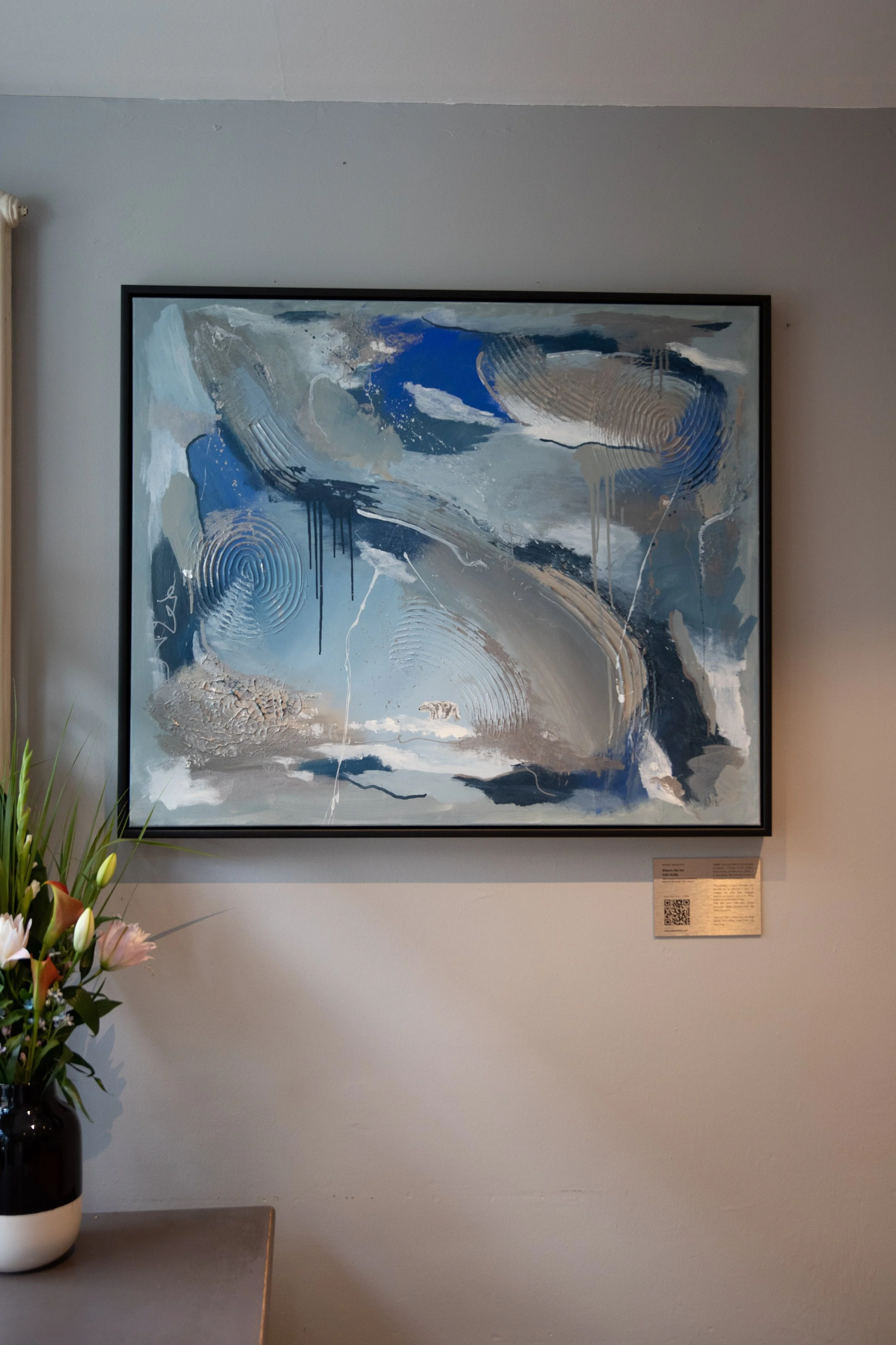 Where the Ice Still Holds, abstract acrylic painting in blue and grey by Sabrina Richter, framed and hanging on a wall