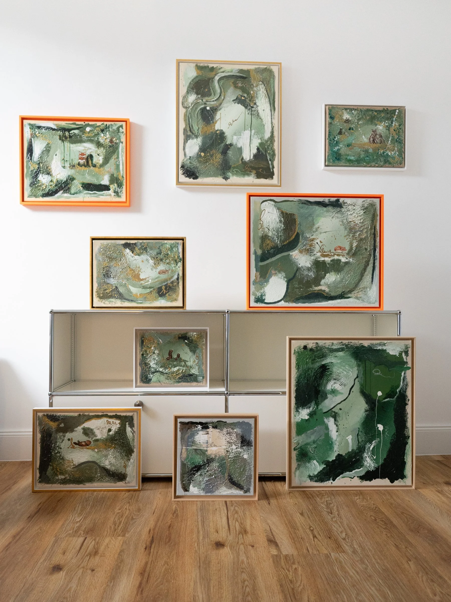 Give It Time shown with all nine Secrets of the Forest paintings on a gallery wall – Bilderwand abstrakte Kunst by Sabrina Richter