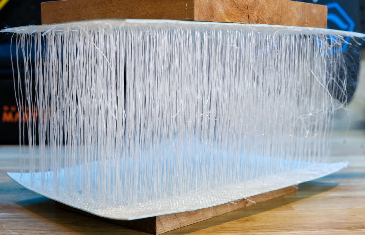 A cut-out section of paddleboard showing the internal drop stitched fibers running from top to bottom.