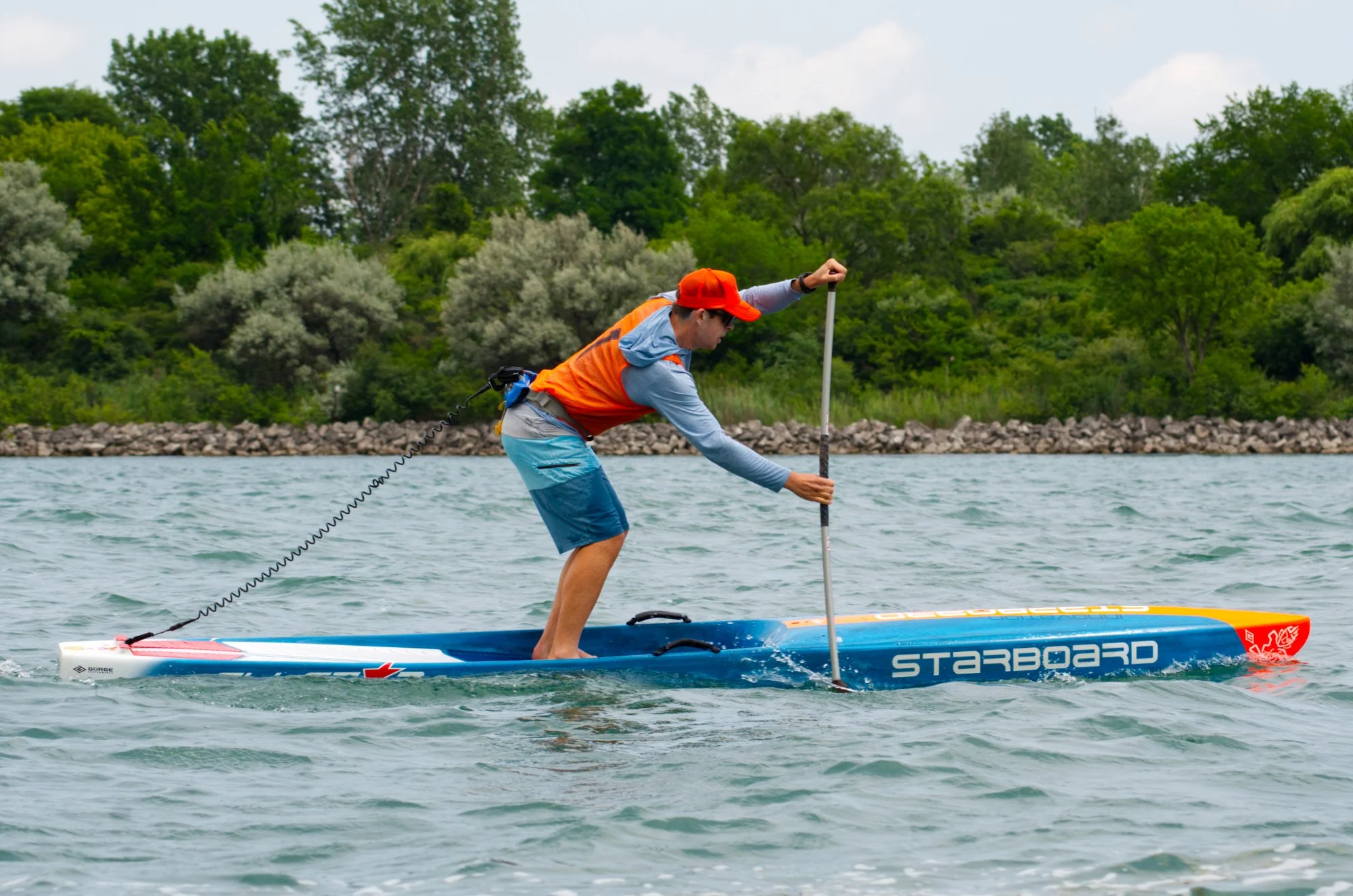 paddle boarder using excellent stroke technique during a race