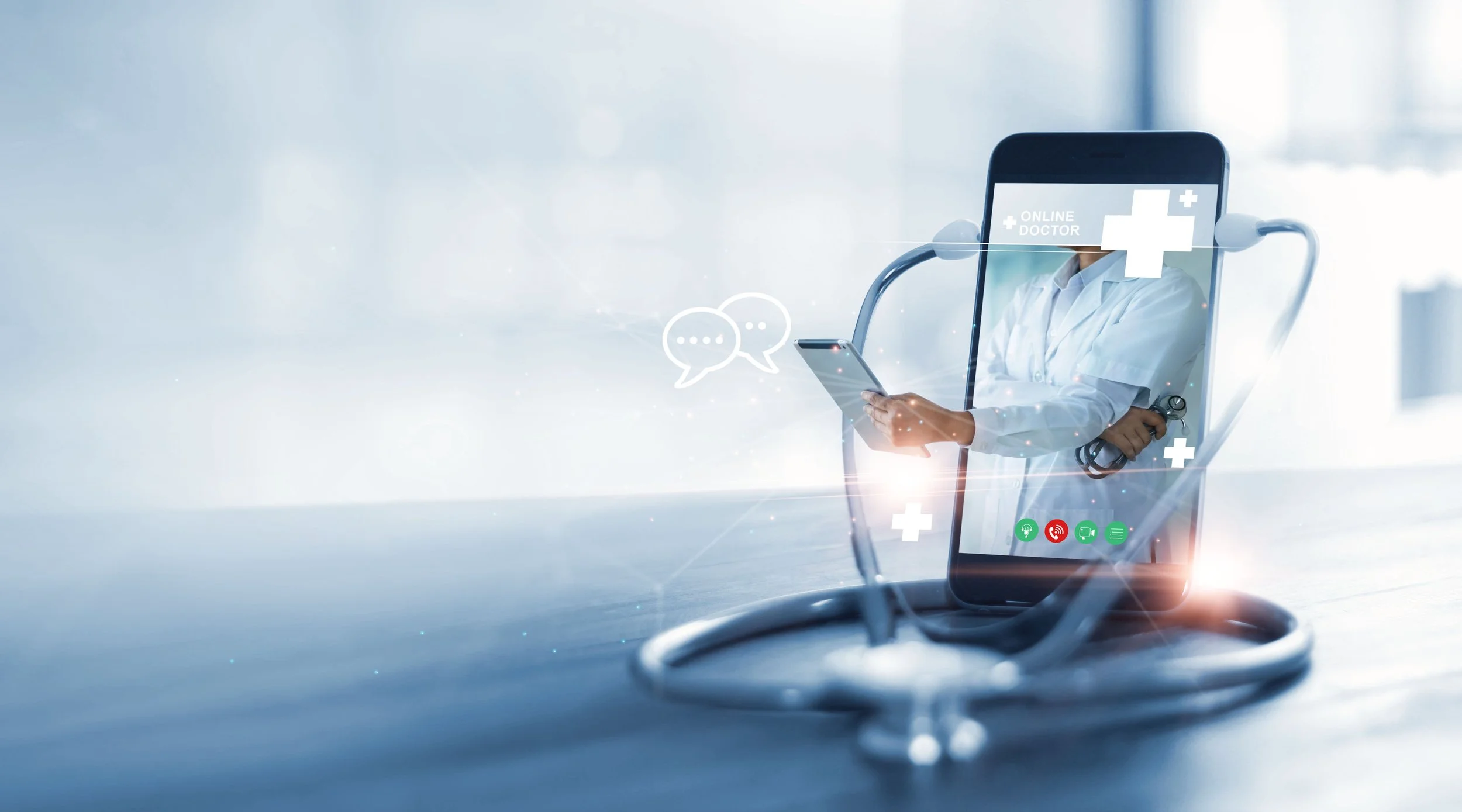 A doctor in a white coat and with a stethoscope is holding a smartphone and appearing on a transparent screen, with icons of communication and medical symbols, representing telemedicine or virtual healthcare.
