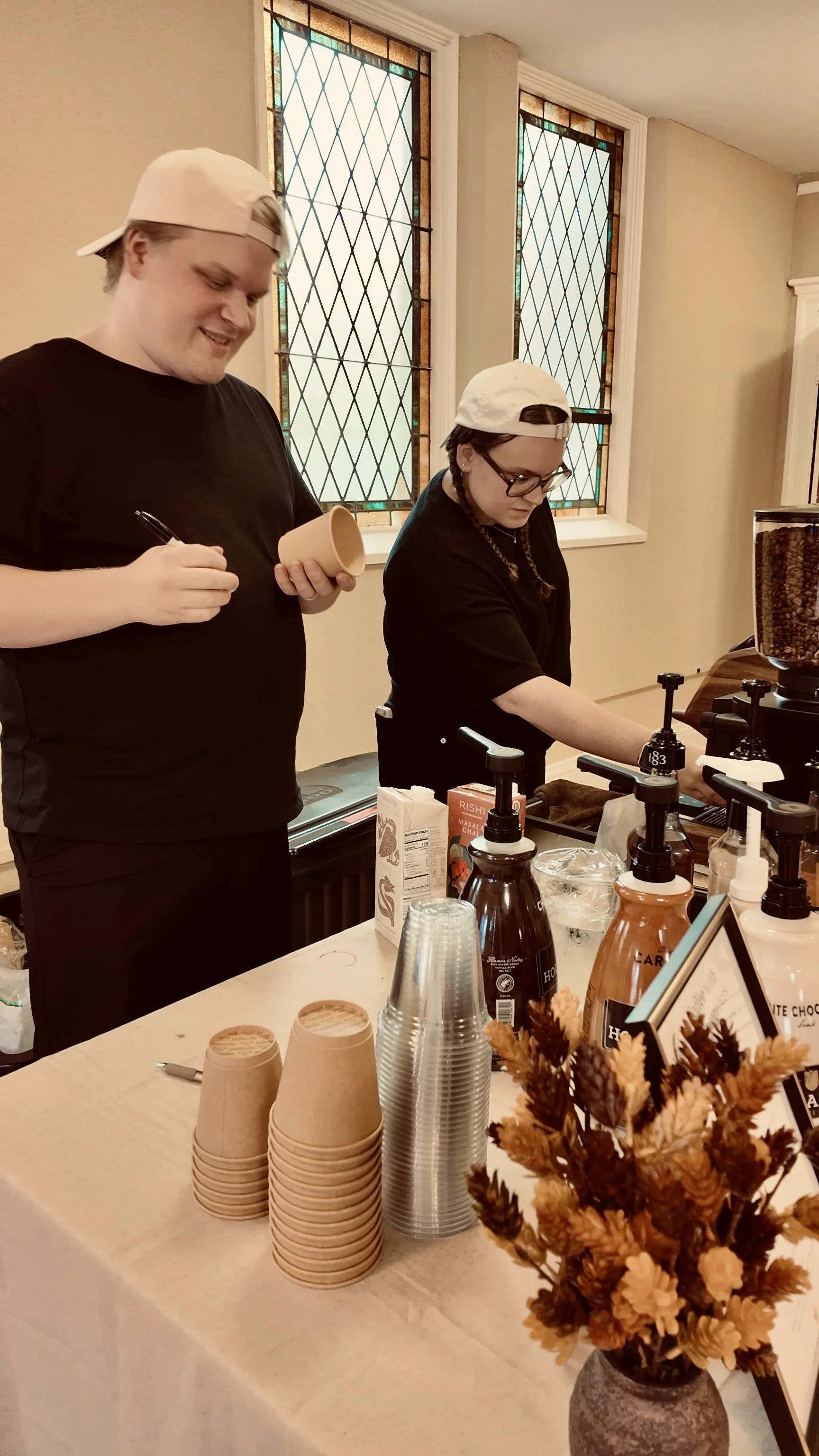 Coletrane and Riley of Bard & Brew preparing espresso drinks at Judson Memorial Baptist Church in Minneapolis.
