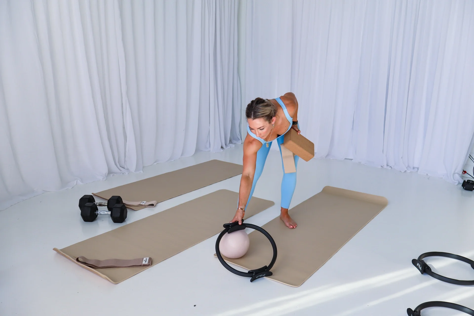 Fearless Movement Oak Flats setting up small group mat pilates and movement classes with pilates ring, ball, bands and blocks