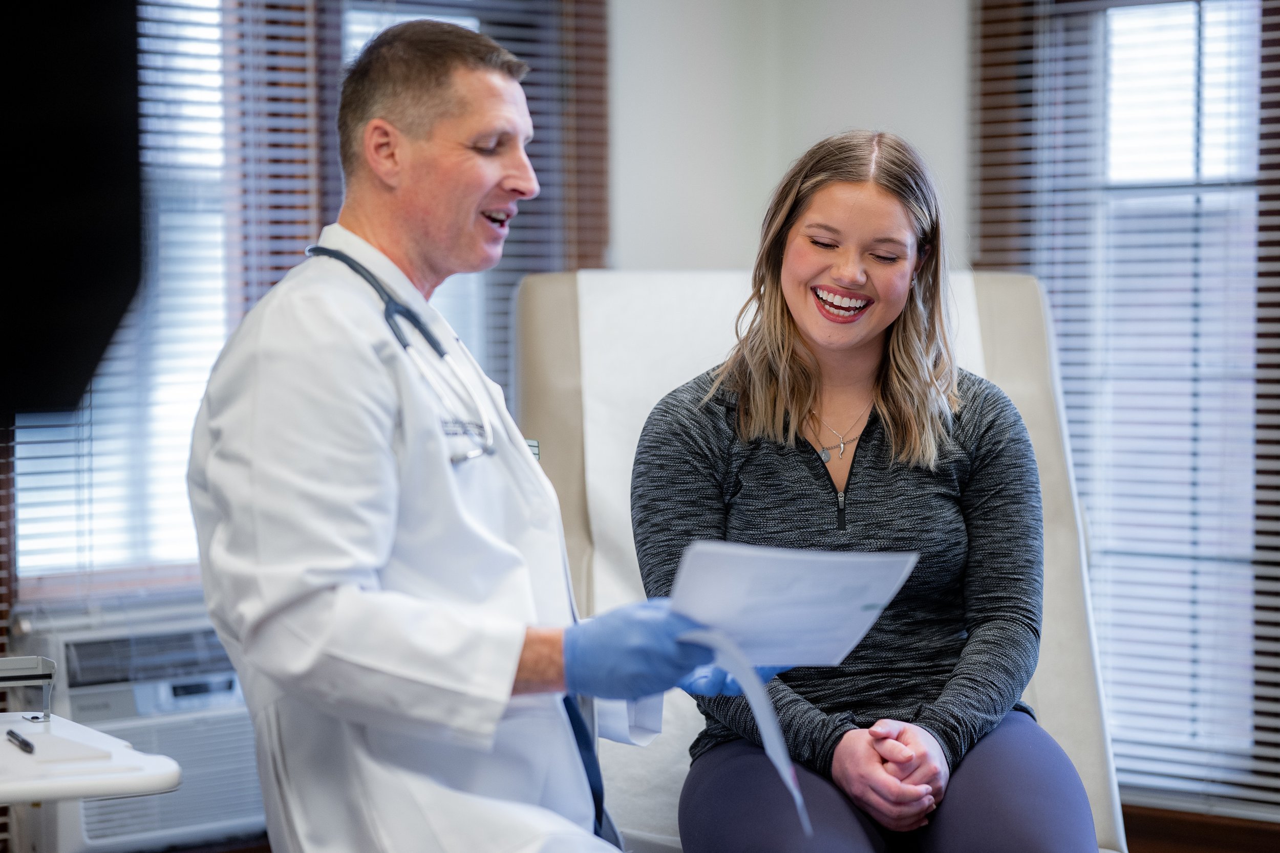Doctor and patient smiling and discussing a document