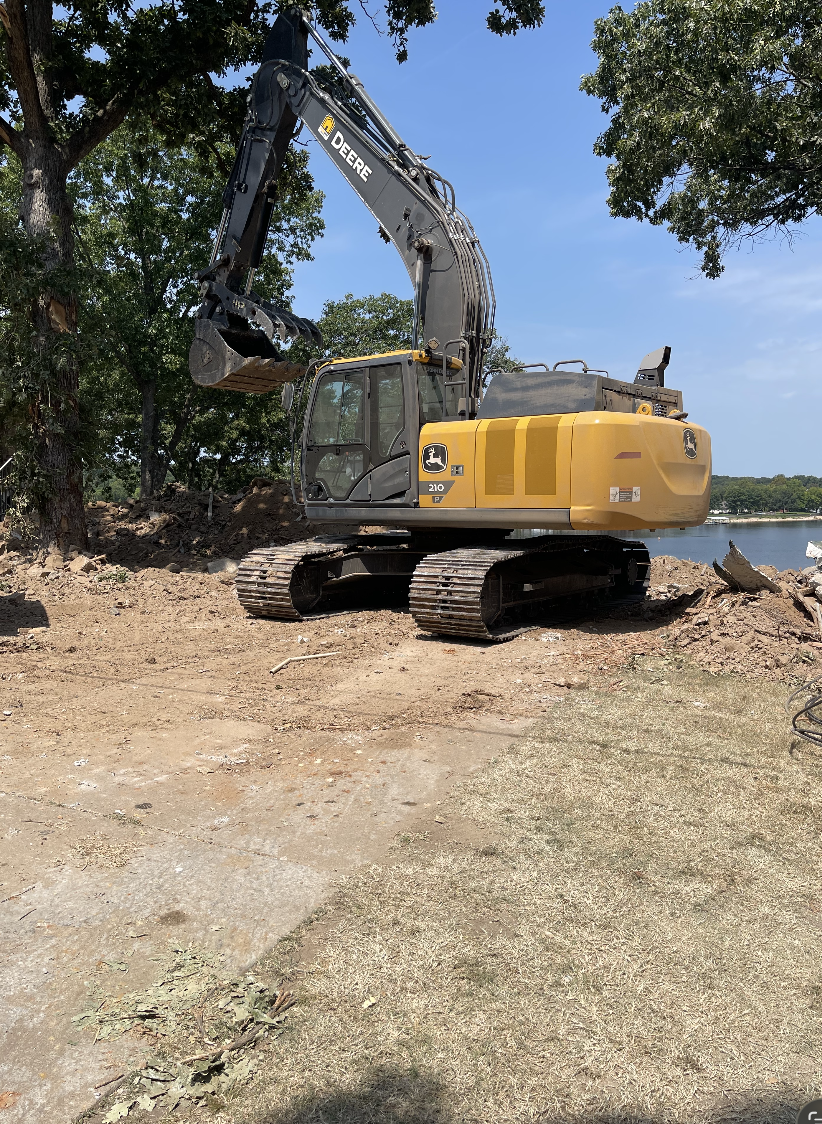 Earthworks by Justin using an excavator for demolition and site cleanup near Tulsa, Oklahoma.